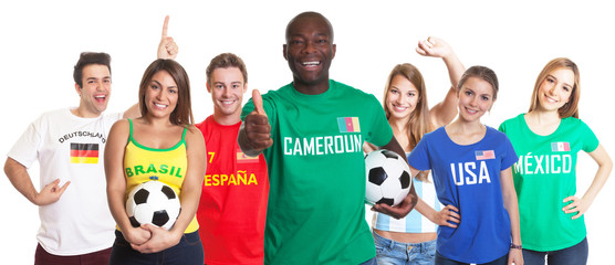 Football fan from Cameroon showing thumb with other fans