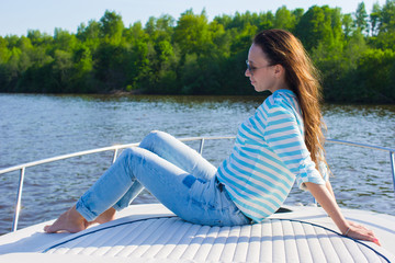 Young woman relaxing on yacht in summer day