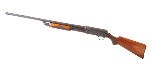 Pump-action shotgun with wood stock and fore end isolated on a white background - obrazy, fototapety, plakaty
