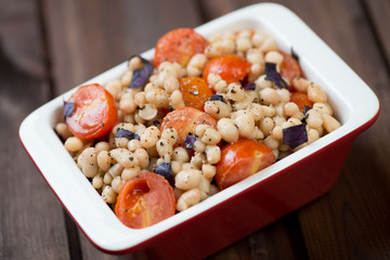 Roasted white beans with cherry tomatoes in a glass bowl