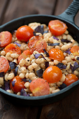 Close-up of roasted white beans and cherry tomatoes, studio shot