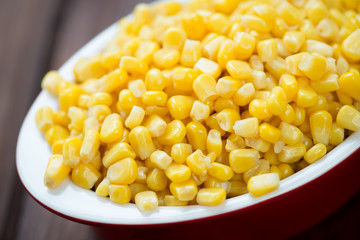 Glass bowl with sweet corn kernels, close-up, horizontal shot