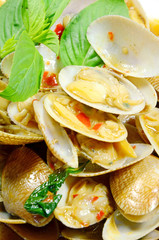 STIR FRIED CLAMS WITH ROASTED CHILI PASTE AND THAI BASIL LEAVES.