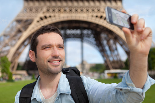 Young attractive tourist taking selfie in Paris