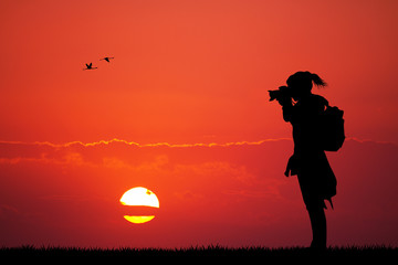 girl photographer at sunset