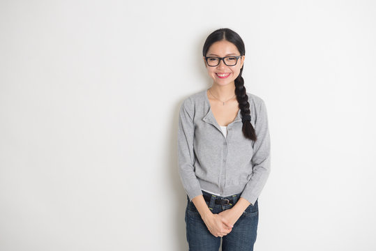 Asian Young Female Smiling With Plain Background