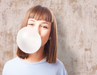 girl doing a bubble with a chewing gum on a white background