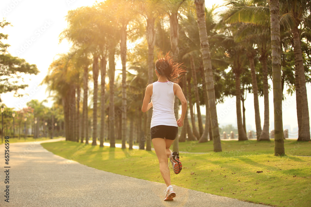 Poster young fitness woman runner athlete running at tropical park