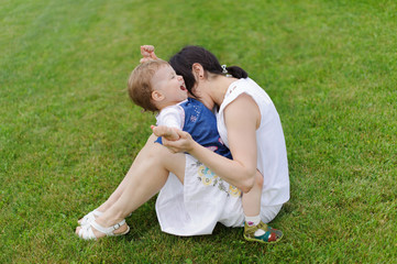 Mother Biting Laughing Daughter