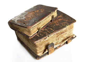 Ancient worn books with leather cover on light background