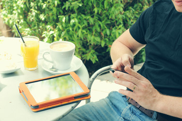 close up man's hands using tablet