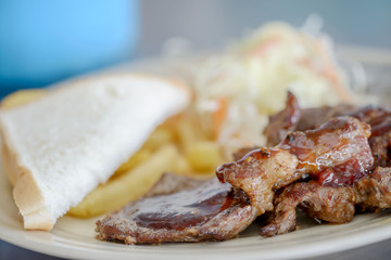 Grilled Pork  steak with french fires ,salad and bread