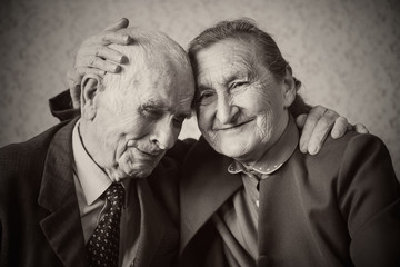 Cute 80 plus year old married couple posing for a portrait