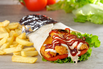 Tortilla with Chicken nuggets, french fries and vegetables