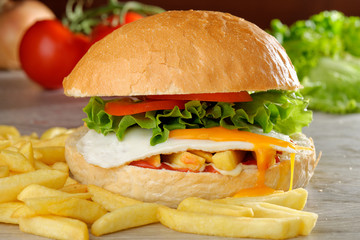 Big veggie burger with egg, fresh vegetables and french fries