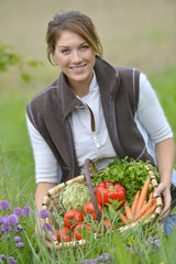 Beautiful woman holding basket of vegetables