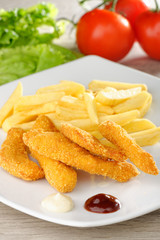 chicken nuggets/sticky fingers and french fries on a white plate