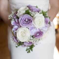 closeup bride holding bouquet of roses