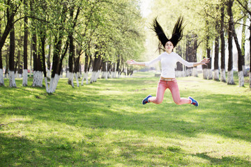 beautiful girl jumping in park