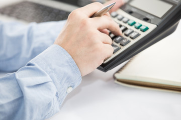 Businessman analyzing investment charts with laptop