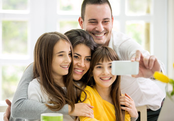 family with little girls making self portrait