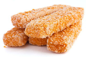 Frozen bread crumbed fish fingers on white