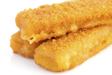 Fried fishfingers on white surface