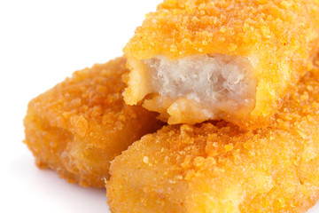 Fried fishfingers on white surface