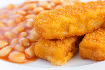 Plate of baked beans with fried fishfingers