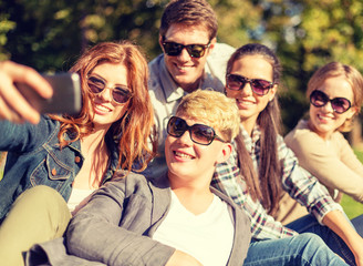 teenagers taking photo with smartphone outside