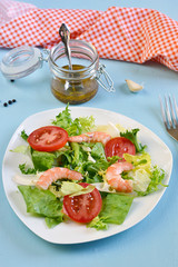 Salad with tomato, king shrimps and sauce vinaigrette