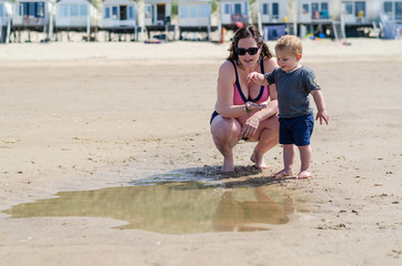 Fototapeta premium little boy splashes in a pool on the beach