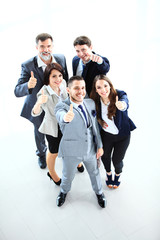 Top view of successful young business people showing thumbs up 