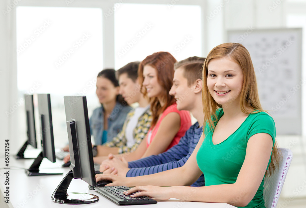 Wall mural female student with classmates in computer class