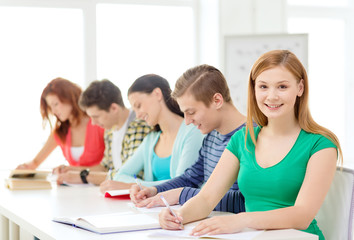 students with textbooks and books at school