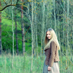 Portrait of romantic fashion young woman smile in the woods.