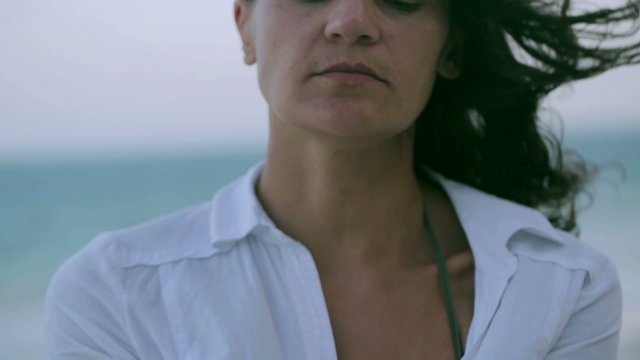 Woman holding shells on the beach, closeup, steadycam shot