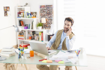 young architect at phone working at office