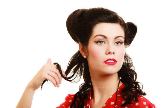 Retro. Coquette pinup girl playing with hair