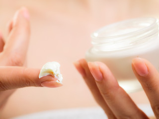 Skin care. Moisturizing cream in female hands