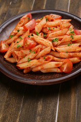 Pasta with tomato sauce on plate on table close-up