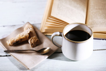 Cup with hot coffee on color  wooden background