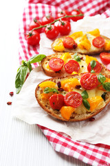 Tasty bruschetta with tomatoes, on table