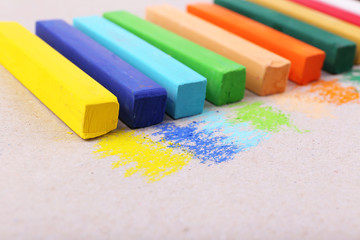 Colorful chalk pastels on color paper background