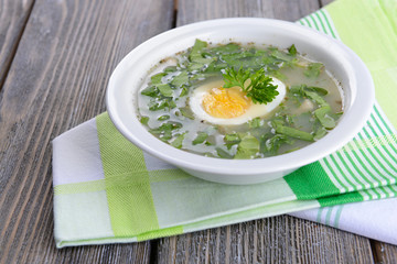Delicious green soup with sorrel on table close-up