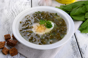 Delicious green soup with sorrel on table close-up