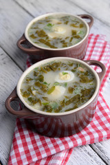 Delicious green soup with sorrel on table close-up