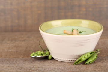 Tasty peas soup on wooden table