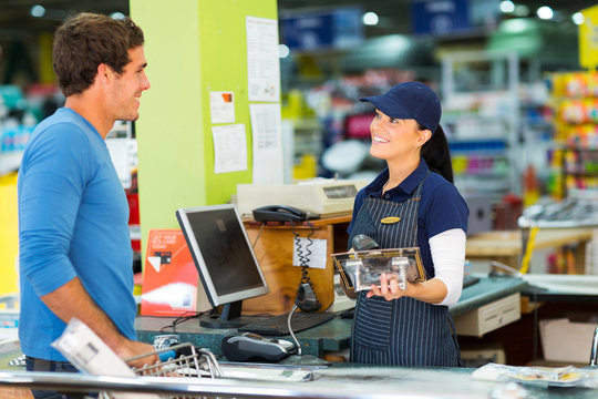 young man paying at till point in hardware store