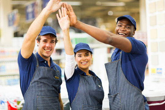 group of hardware store workers high five